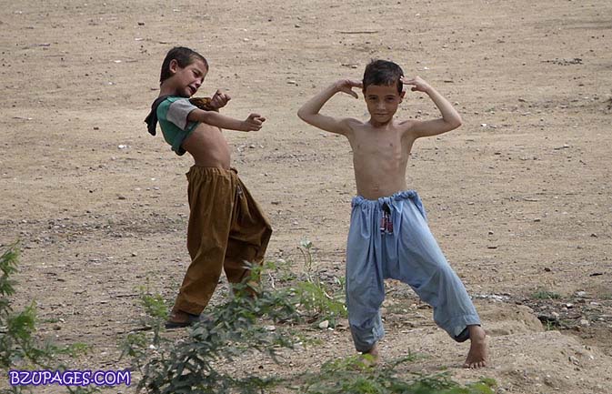 Name:  A boy of Afghan descent points at another with an imaginary machine gun as they play near their .jpg
Views: 812
Size:  86.7 KB