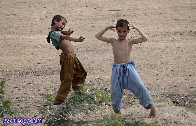 Name:  A boy of Afghan descent points at another with an imaginary machine gun as they play near their .jpg
Views: 779
Size:  86.7 KB