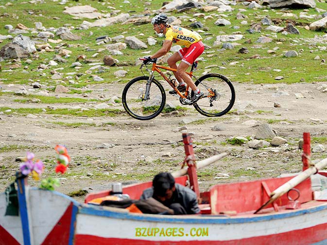 Name:  Martin Haring rides past a man working on a boat..jpg
Views: 430
Size:  126.5 KB