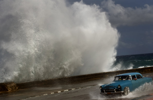 Name:  A driver maneuvers his classic American car along a wet road as a wave crashes against the Malec.jpg
Views: 1119
Size:  37.8 KB
