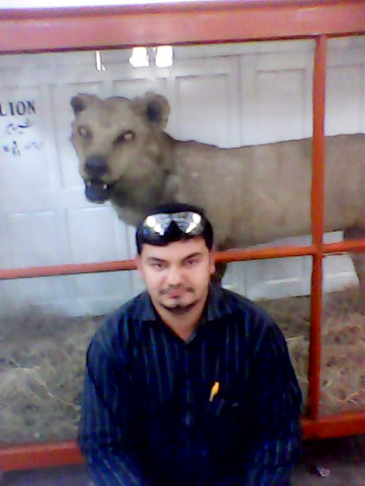 Awais Khan sit in front of Lion.