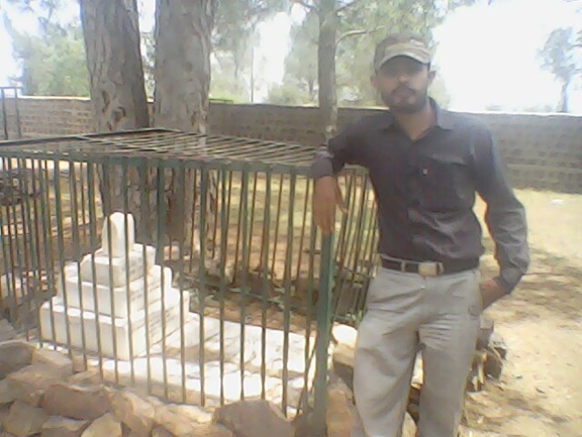 Shoaib is standing near the grave